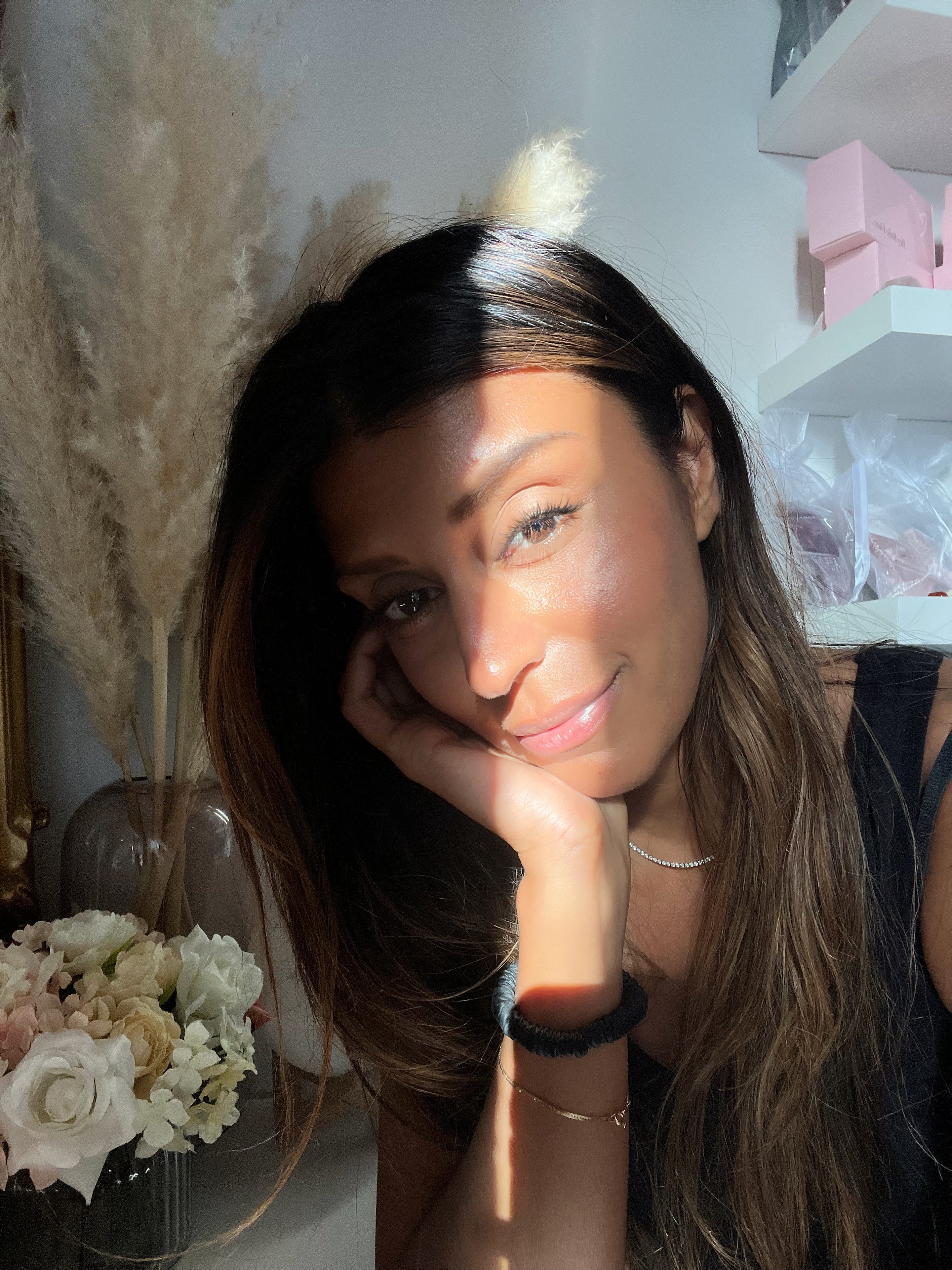 Amrit Singh with long hair posing indoors with decorative elements in the background